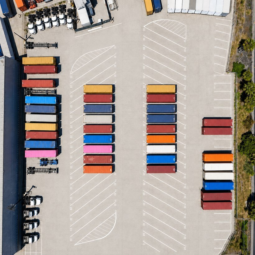 Aerial view of the Whisk Logistics secure yard in Carson, California, showing rows of containers in numbered stalls and open capacity, five miles from the Ports of Los Angeles and Long Beach
