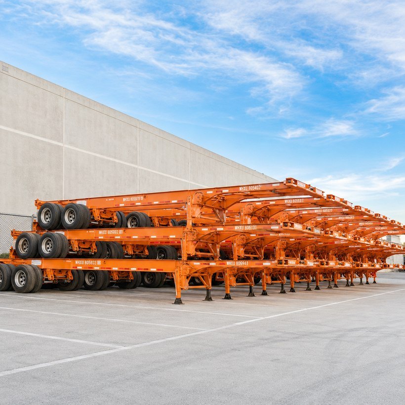 Rows of stacked Whisk Logistics private chassis at the Carson yard, marked WHXU, ready for dispatch