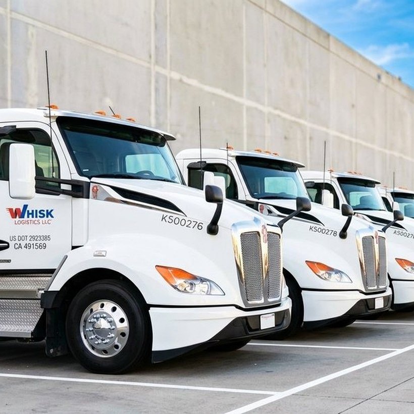 Whisk Logistics tractor fleet lined up at the Carson yard, unit numbers and US DOT 2923385 visible on the lead truck